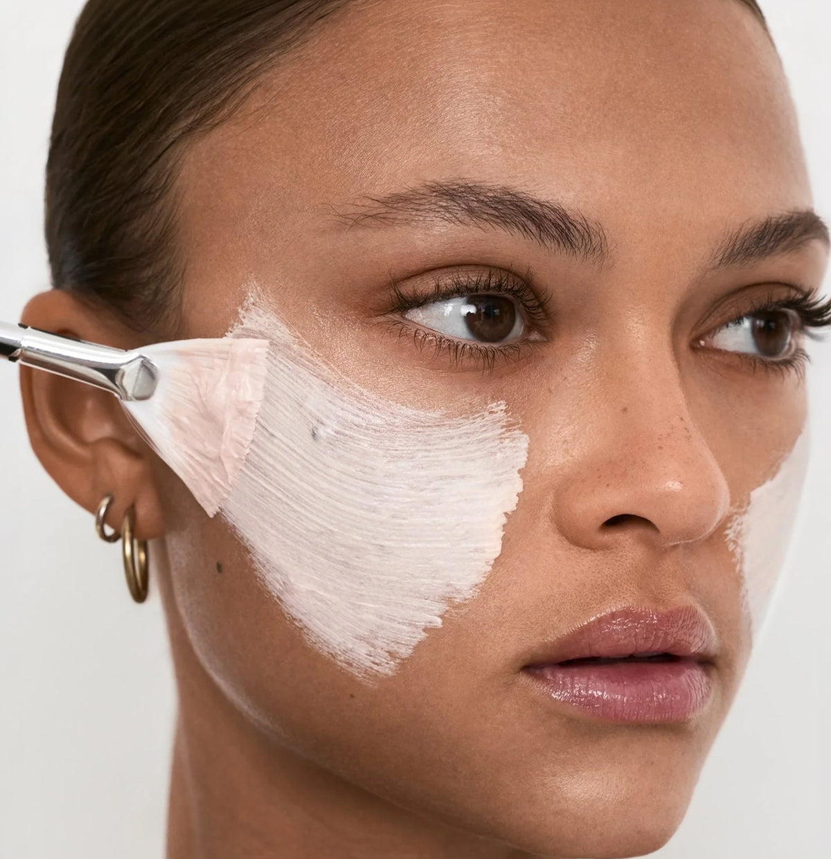 Model applying skincare, Fall Renewal protocol